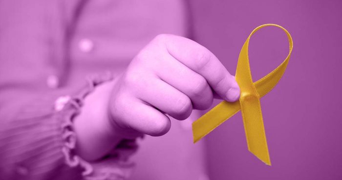Mão segurando faixa amarela em homenagem ao 'Setembro Amarelo'.