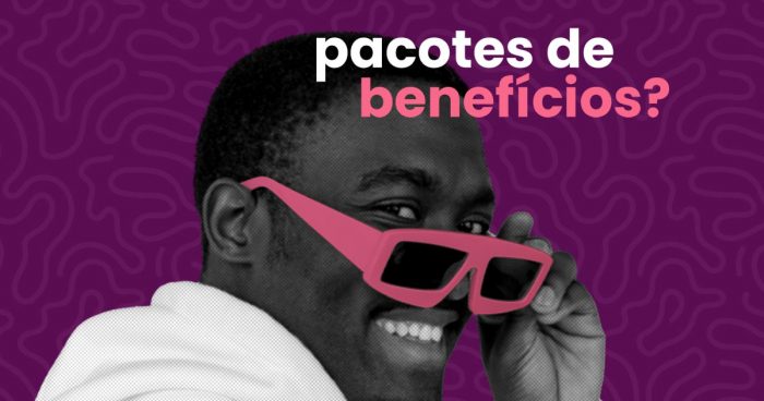 homem sorrindo enquanto segura óculos de sol, na cor rosa, próximo ao rosto